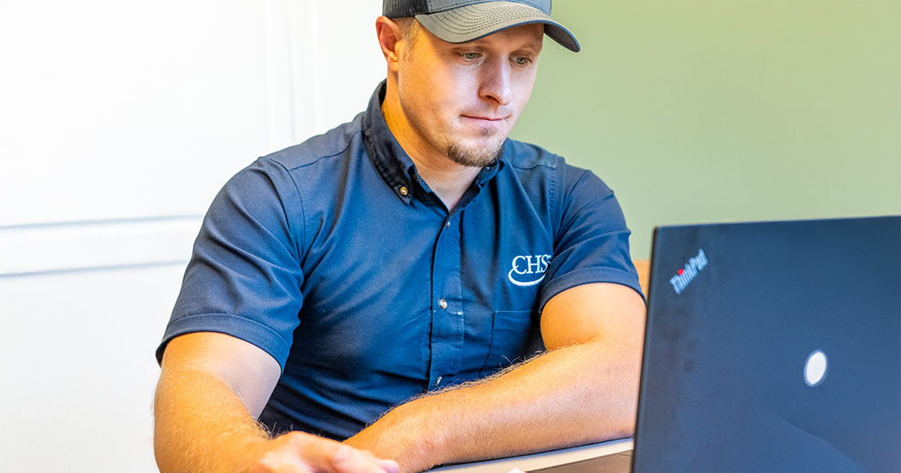 CHS employee working on a laptop