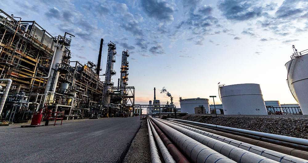 Pipelines at a refinery at sunset