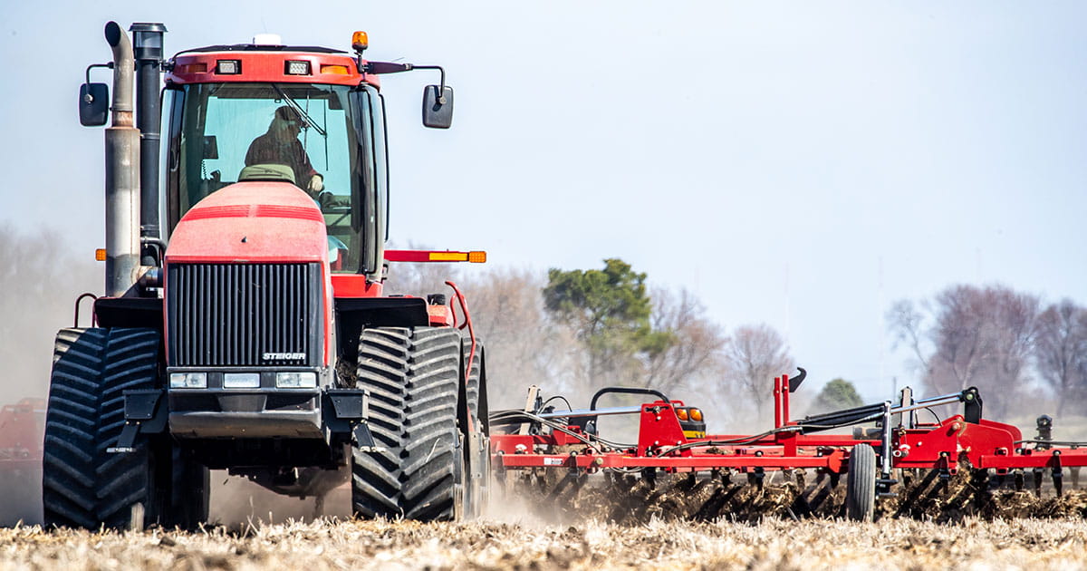 Producer driving a tractor in a field