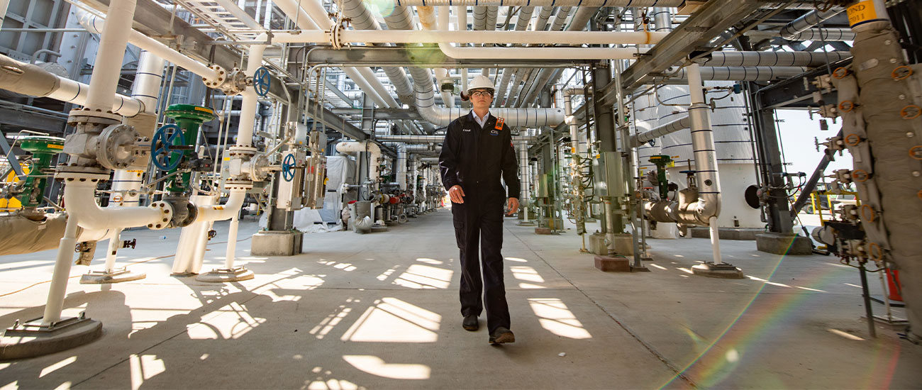 Engineer walking throughout a refinery
