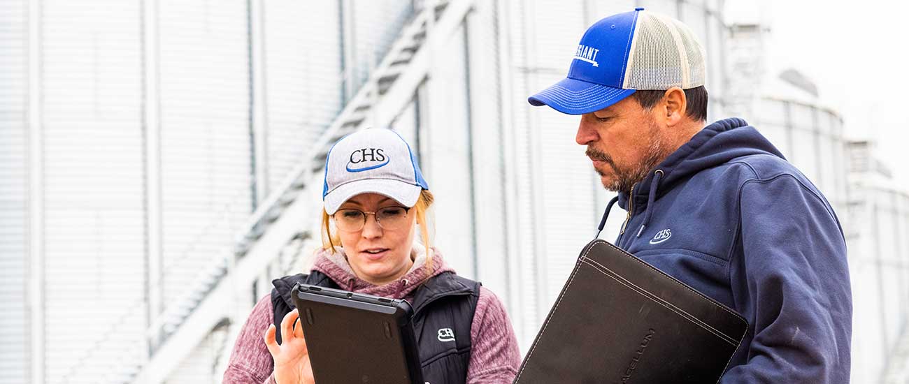 two people discussing business, one with tablet
