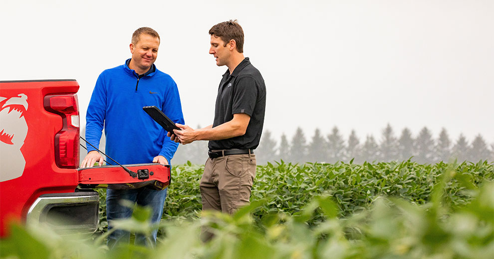 Producer and CHS precision ag specialist looking at an iPad