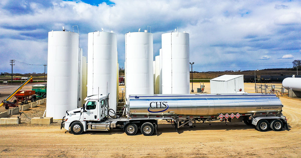 CHS branded delivery truck parked outside a fuel terminal