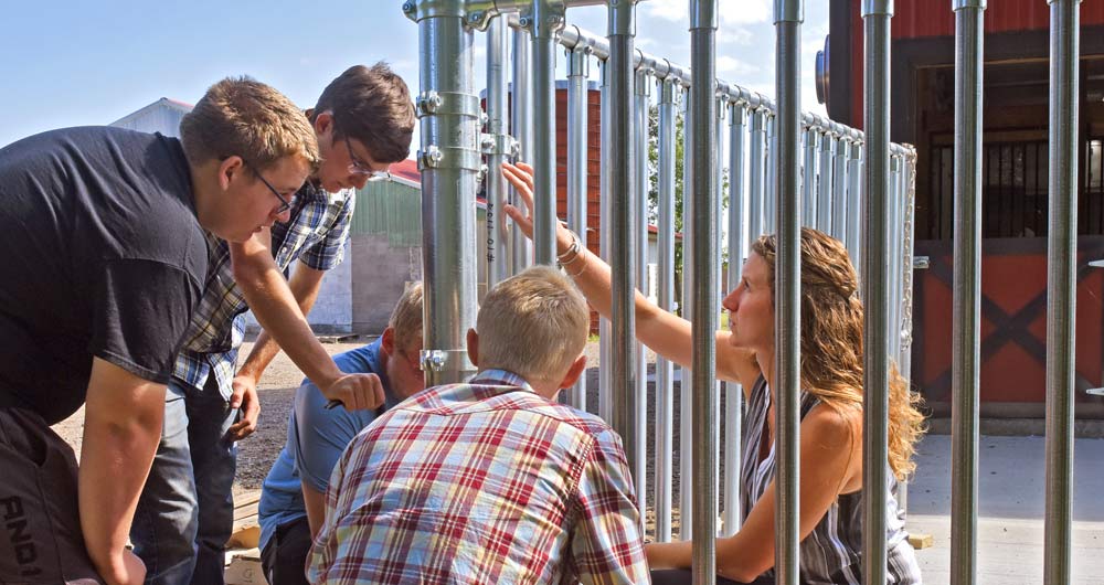 Group of people fixing a fence