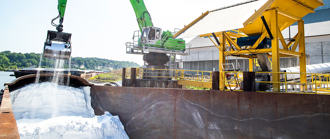 Scooping crop nutrients out of a barge