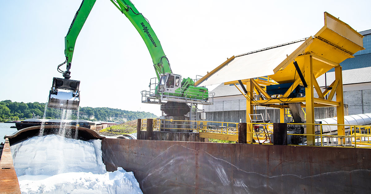 Scooping crop nutrients out of a barge