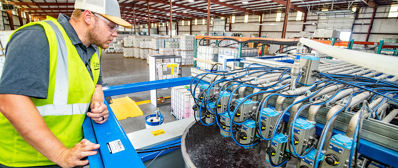 CHS blender and operator working on the seed treatment operation and delivery