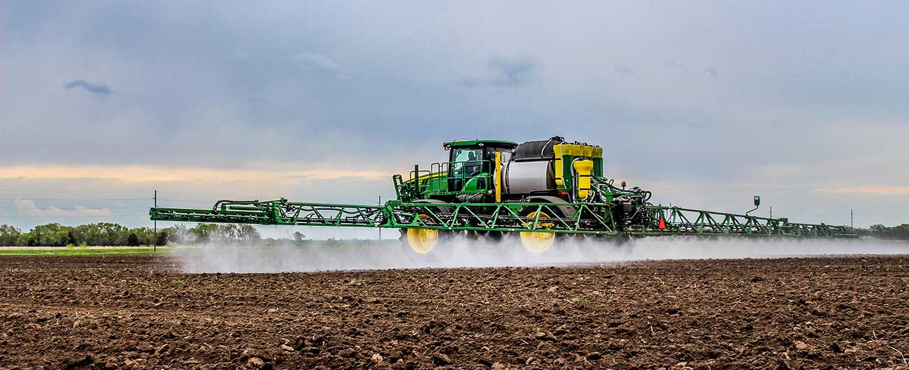 Tractor sprayer on a field at a family farm