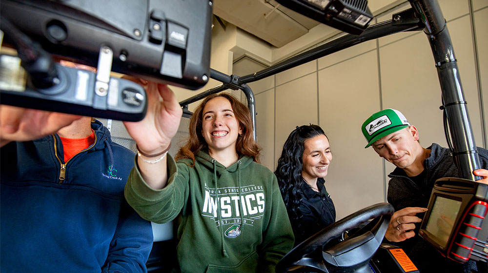 Four people testing precision ag equipment.