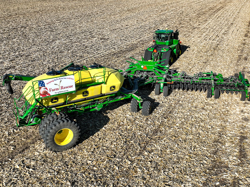 A large tractor and planter in a field