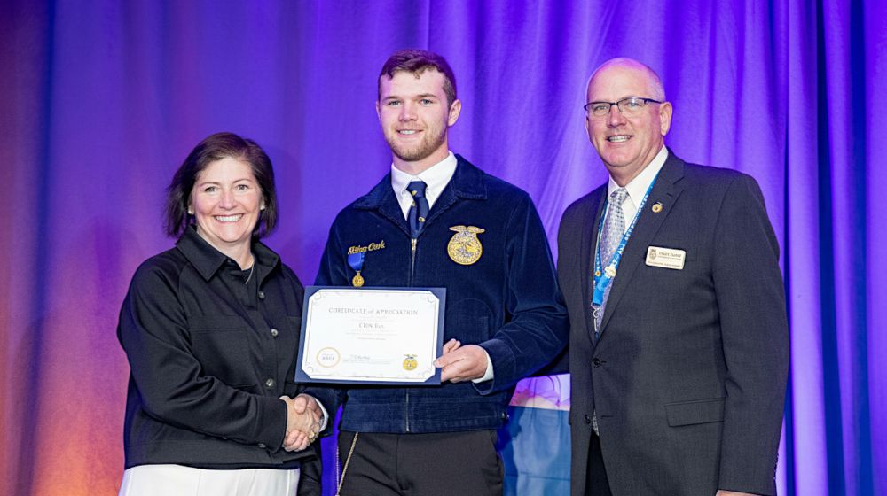 Three people accepting an award.