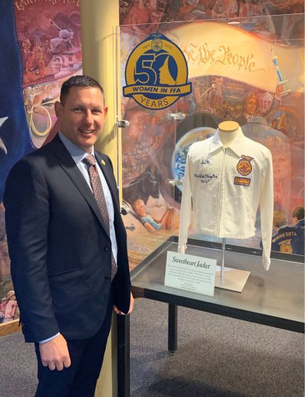 man standing next to a jacket