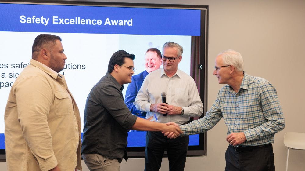 Men shaking hands as they receive Safety Excellence Award 